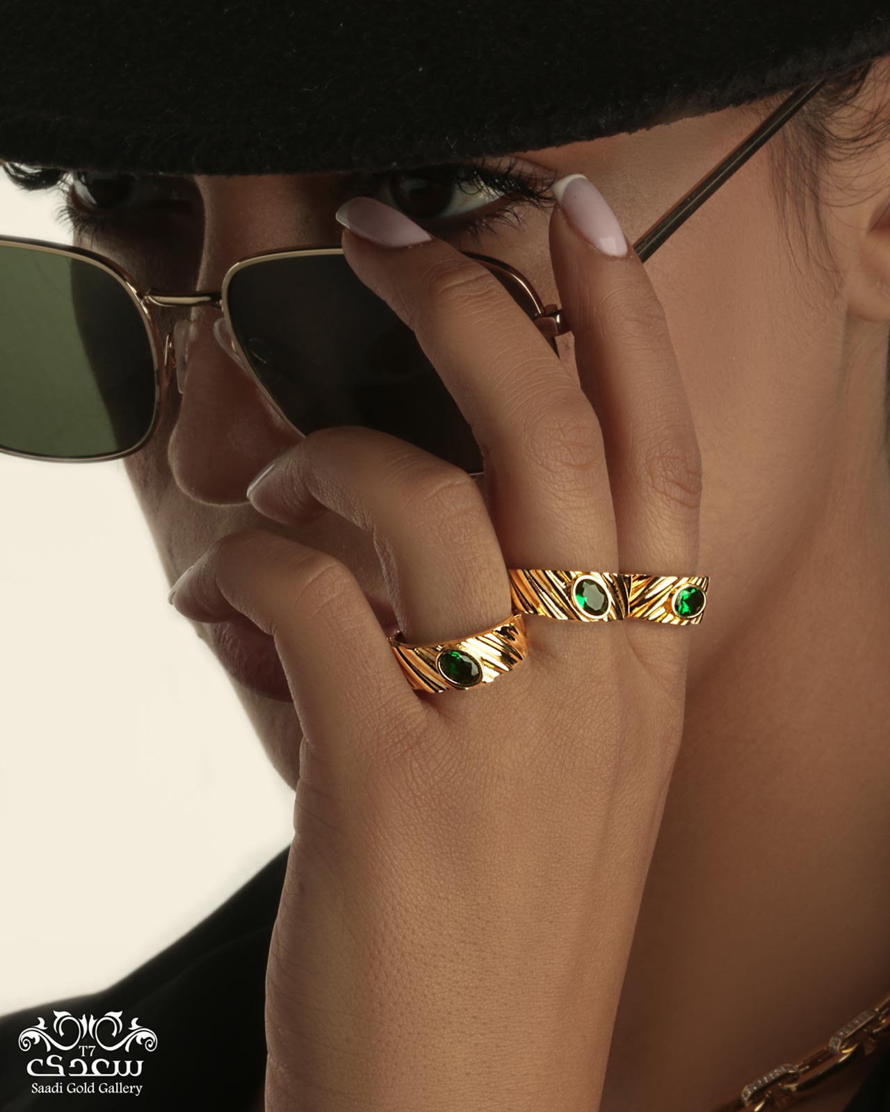 A WOMAN WHO IS WEARING GLASSES AND RINGS